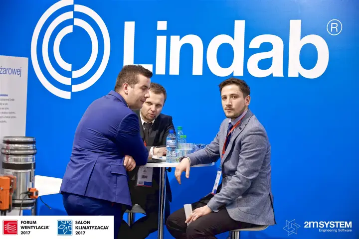 Meeting at a high table under the large Lindab logo at Forum Wentylacja 2017