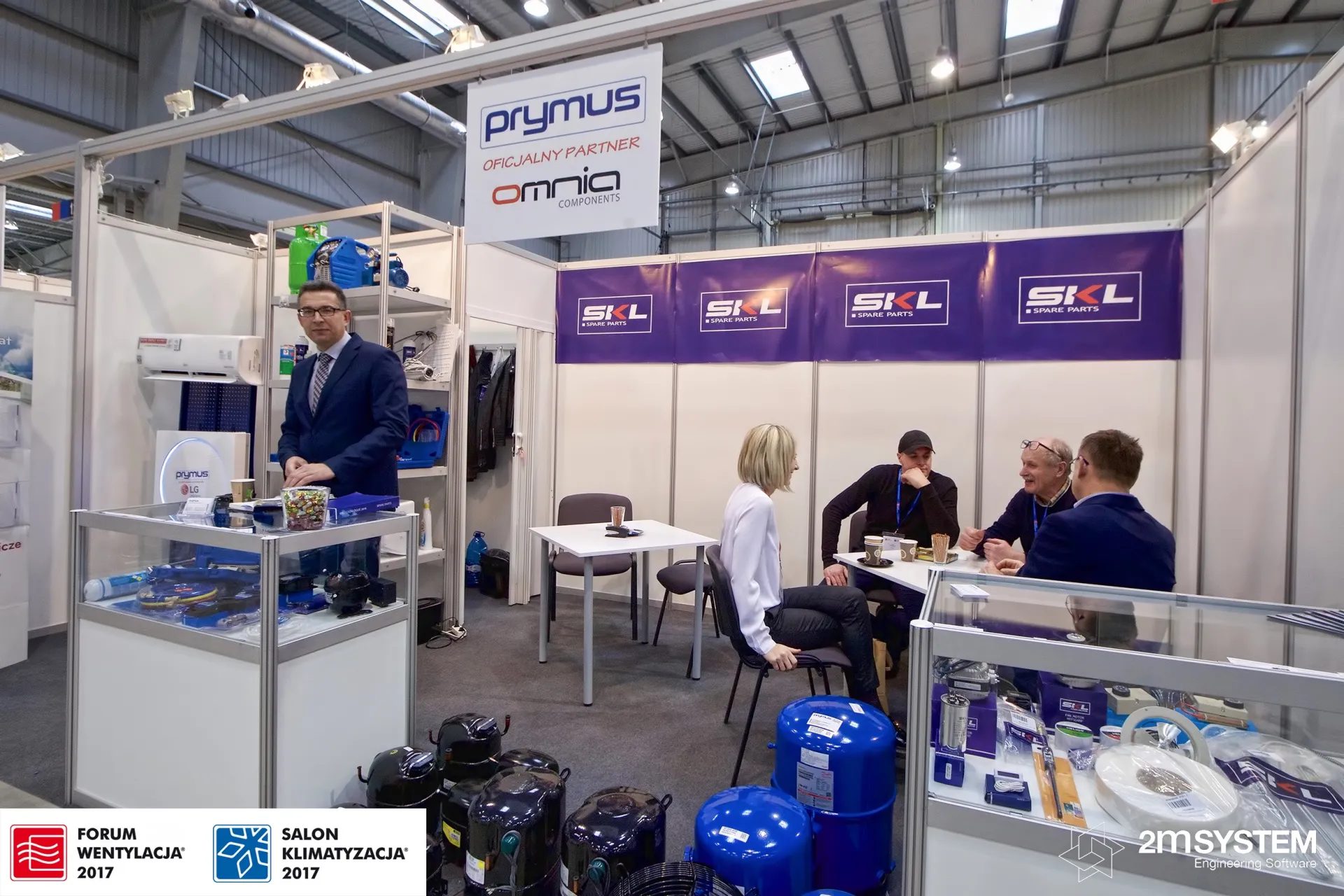 Prymus meeting table under SKL Spare Parts banners with compressors in front at Forum Wentylacja 2017