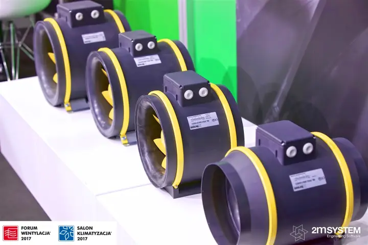 Row of Harmann inline duct fans with yellow rings and impellers at Forum Wentylacja 2017
