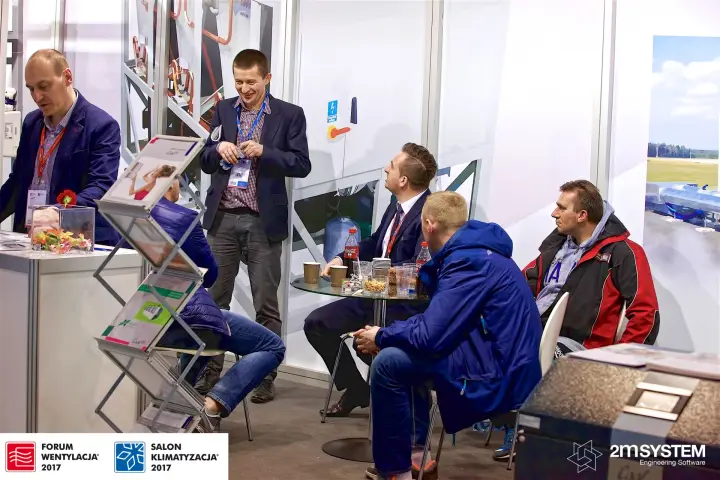 Seated visitors chatting in the stand's meeting corner