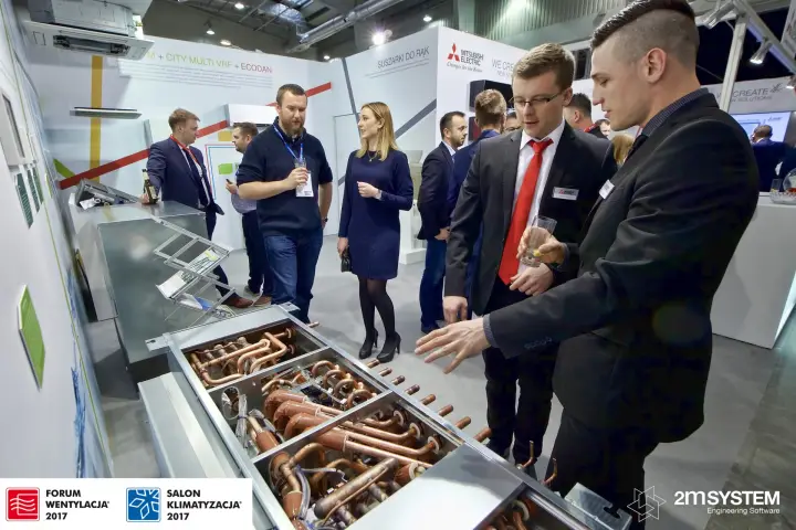 Staff explain the copper pipework of an opened unit at Forum Wentylacja 2017