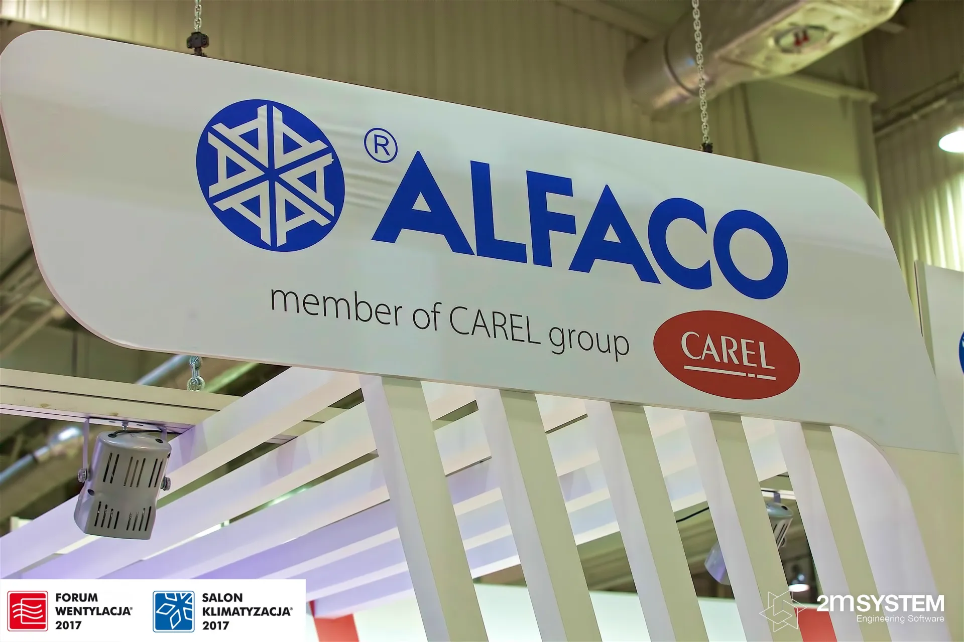Suspended Alfaco sign reading "member of CAREL group" at Forum Wentylacja 2017