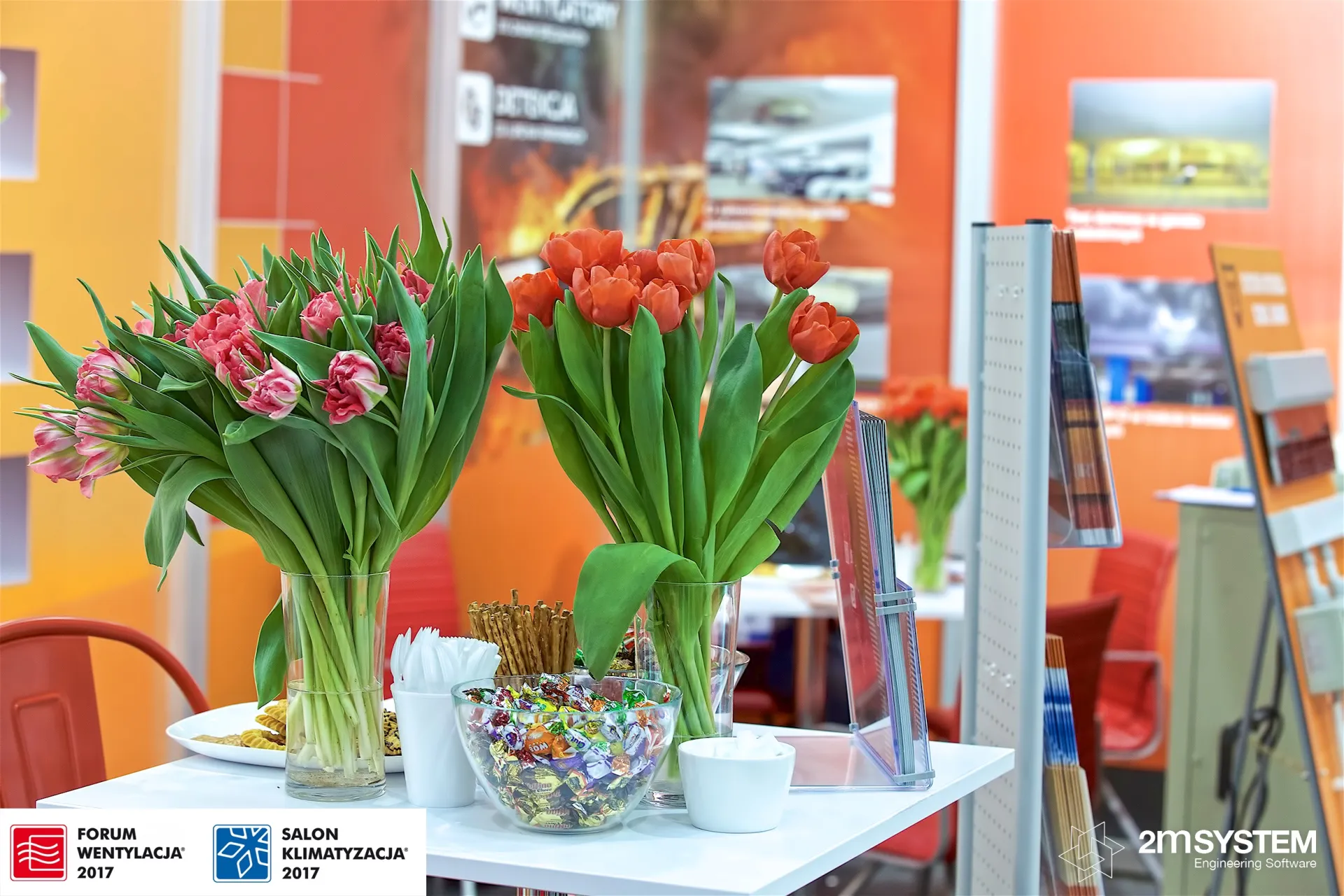 Tulips and sweets on a table at the orange Scrol and Sodeca stand at Forum Wentylacja 2017