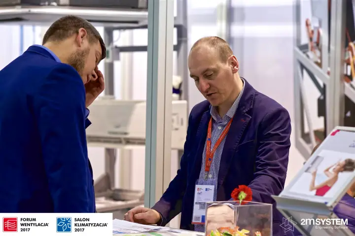Visitor and staff going through printed materials at the counter