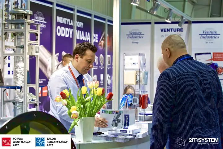 Visitors consult the 2017 Wentylatory catalogue at the Venture Industries stand at Forum Wentylacja 2017