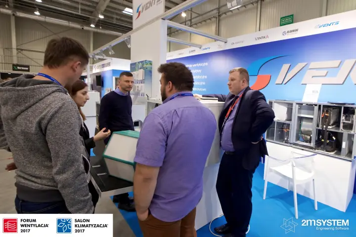 Visitors examine a counterflow heat exchanger core at Vents stand