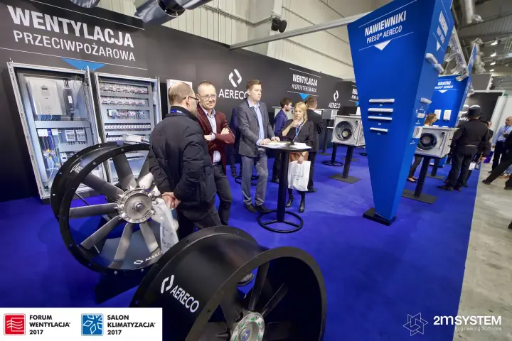 Visitors at a high table among Aereco axial fans and Preso air inlets at Forum Wentylacja 2017
