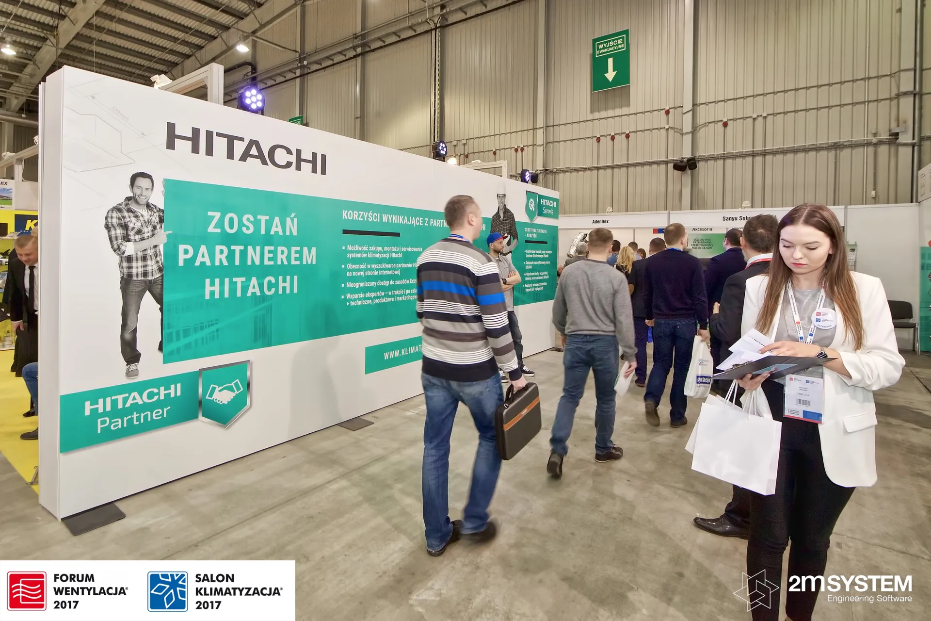 Visitors pass the Hitachi Partner wall along a busy aisle at Forum Wentylacja 2017