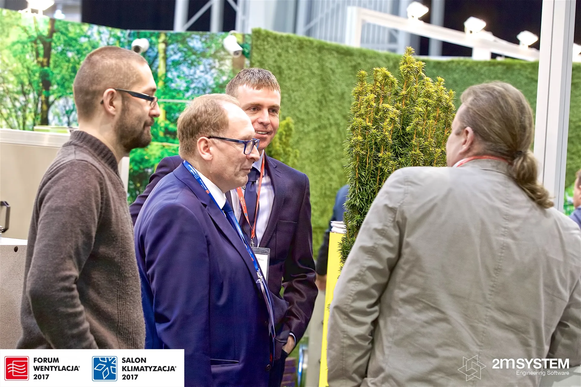 Visitors talking beside the green wall and conifer on the VBW stand at Forum Wentylacja 2017