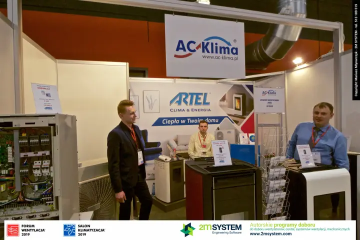AC-Klima team beside Artel pellet stoves and the Artel backdrop