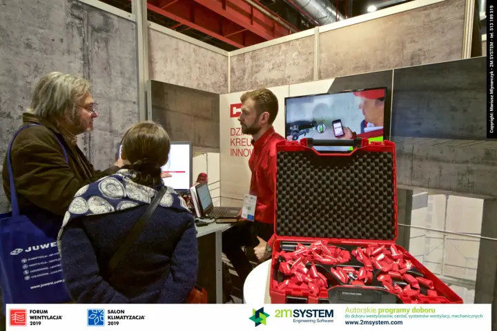 Hilti staff present software on screens next to an open red tool case