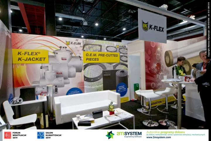 K-Flex lounge area with white sofa in front of K-Jacket graphics at Forum Wentylacja 2019