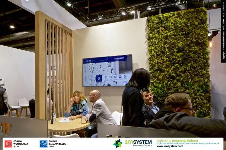 Klima-Therm lounge with moss wall, oak slat screen and product display