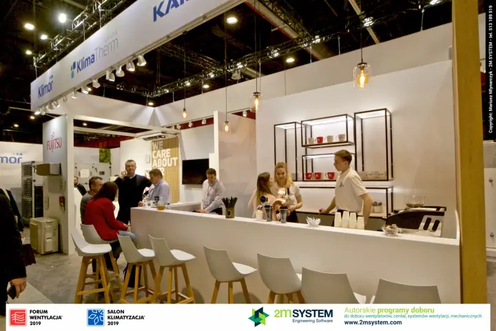 Klima-Therm stand bar with pendant lamps and white stools at Forum Wentylacja 2019