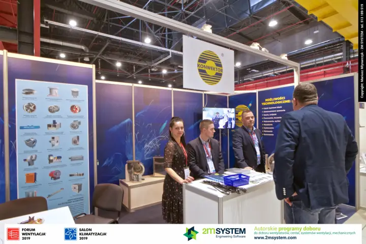 Konwektor staff at the counter with fan range poster and capabilities list at Forum Wentylacja 2019