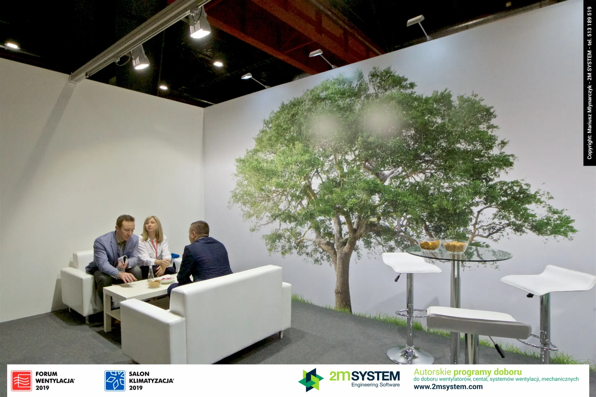 Meeting corner with white sofas beneath the Darco tree mural at Forum Wentylacja 2019