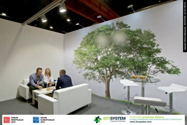 Meeting corner with white sofas beneath the Darco tree mural at Forum Wentylacja 2019