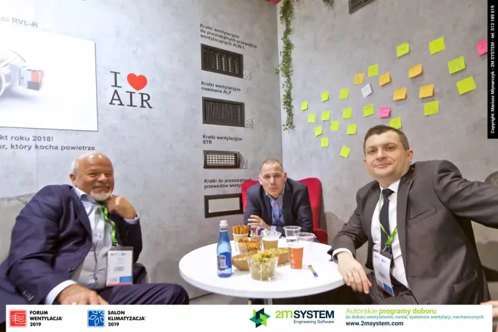 Meeting at the SMAY lounge beside a wall of mounted ventilation grilles at Forum Wentylacja 2019