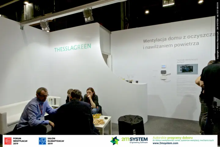 Thesslagreen lounge with white sofa below the green company name at Forum Wentylacja 2019