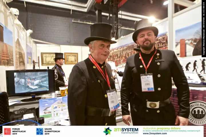 Top-hatted chimney sweeps beside a carbon monoxide poster at Forum Wentylacja 2019