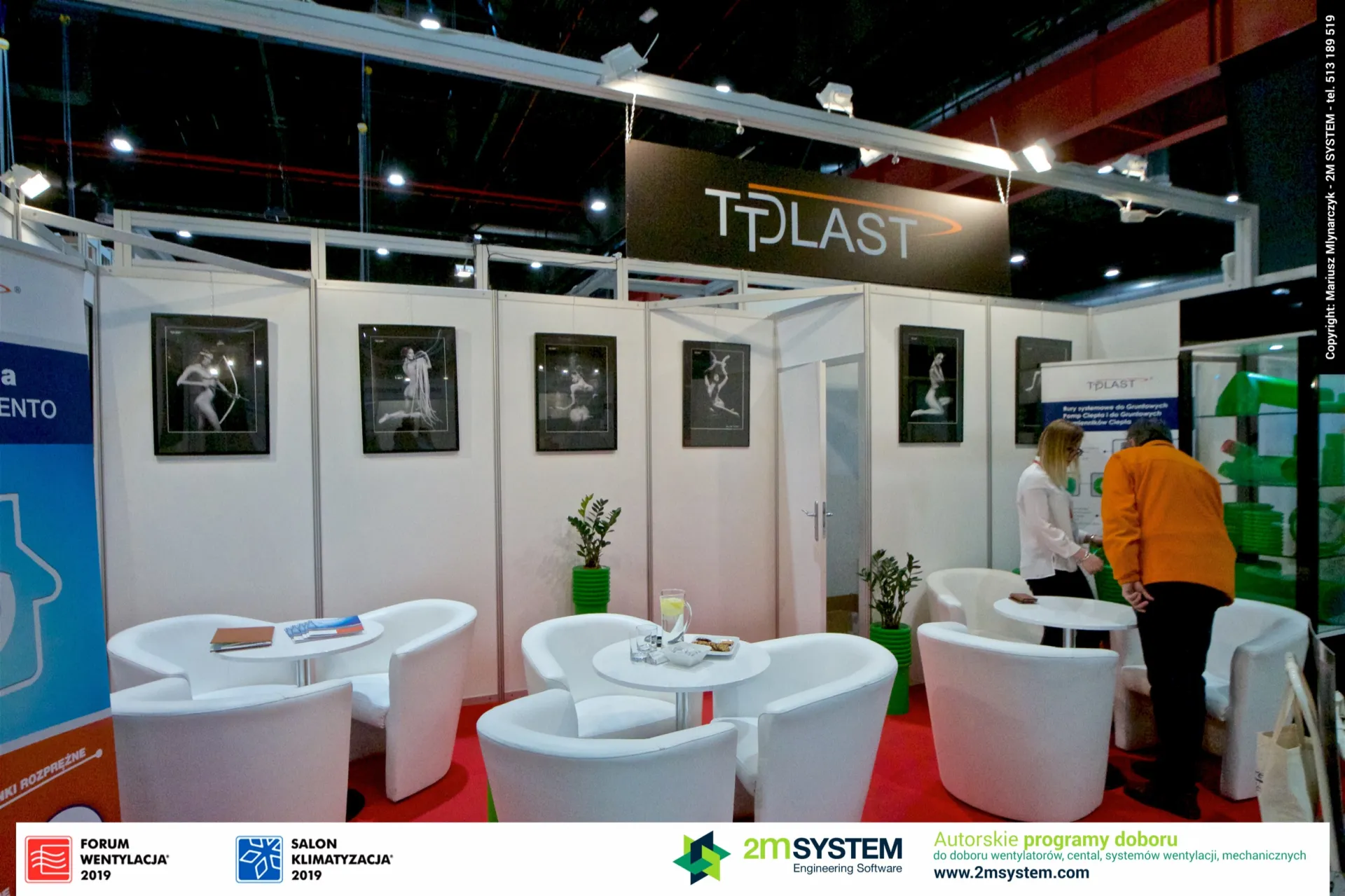 Tplast lounge with white armchairs, framed art prints and green pipe samples at Forum Wentylacja 2019