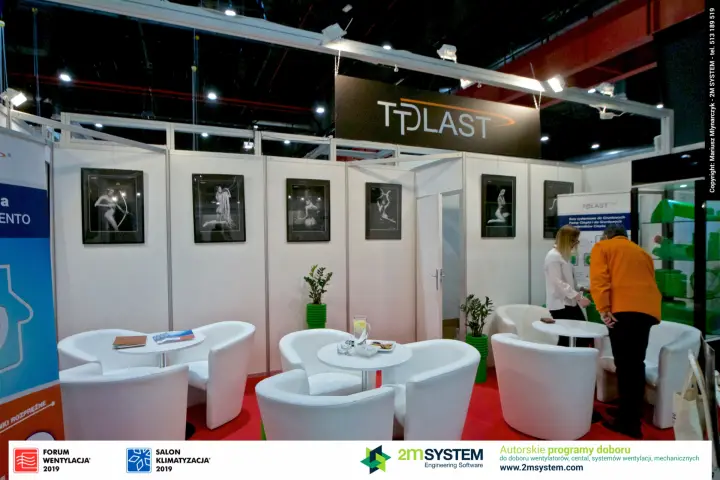 Tplast lounge with white armchairs, framed art prints and green pipe samples