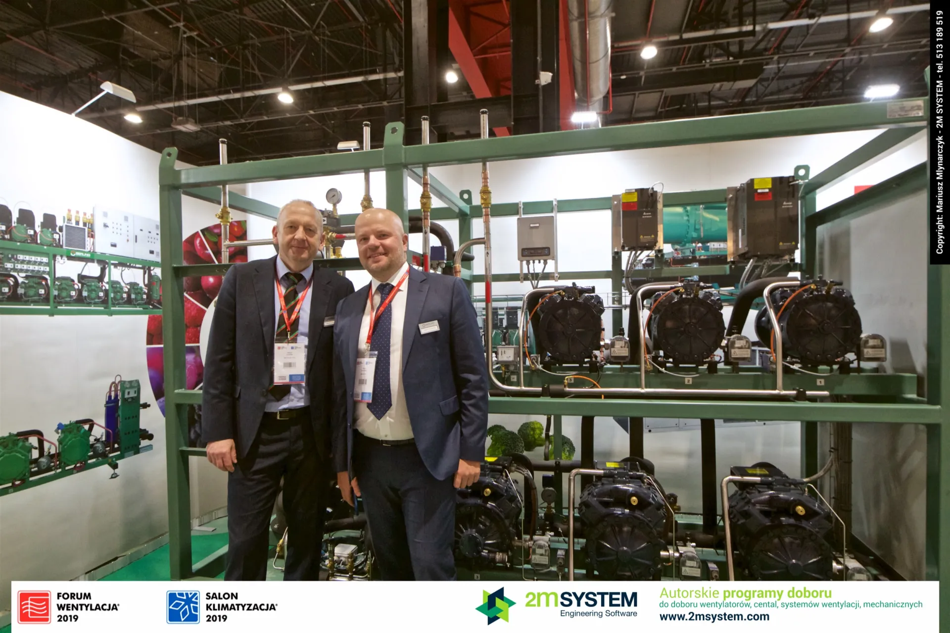Two exhibitors in front of a green-framed Berling compressor rack at Forum Wentylacja 2019