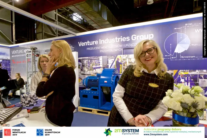 Venture Industries staff with a large blue direct-drive centrifugal fan behind at Forum Wentylacja 2019