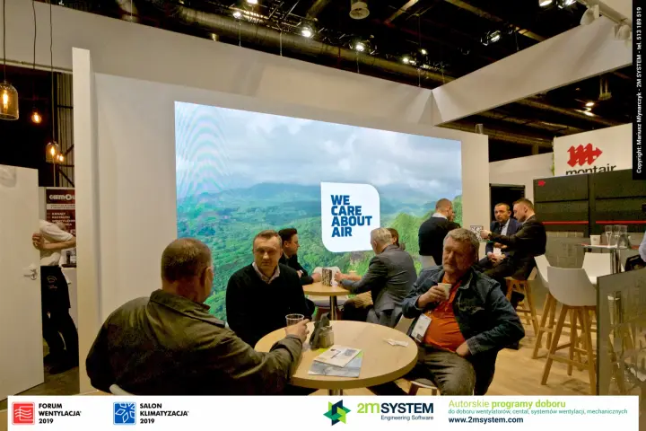 Visitors meet in front of the "We Care About Air" LED wall at Klima-Therm