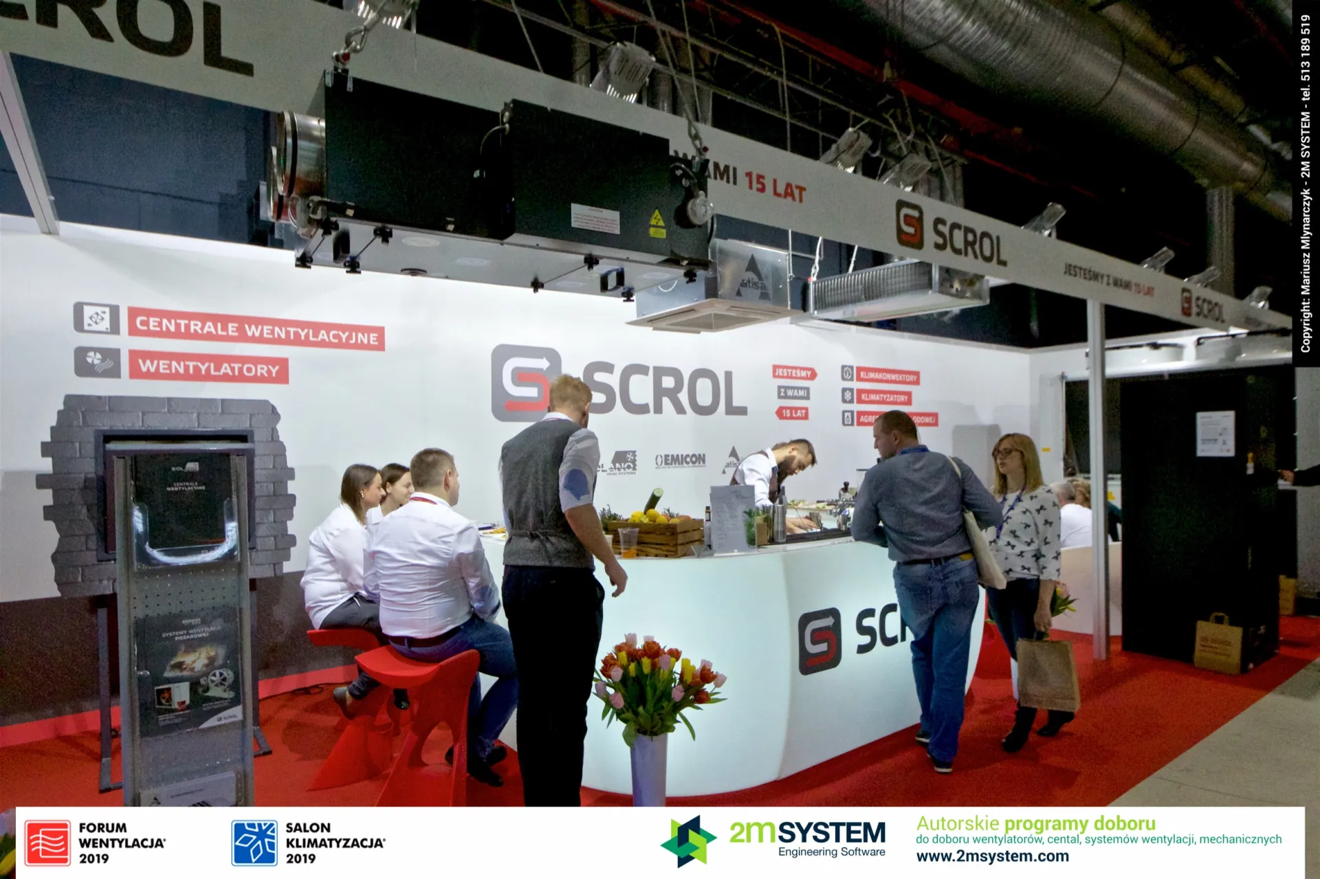 Visitors at the Scrol bar beneath a suspended ventilation unit at Forum Wentylacja 2019