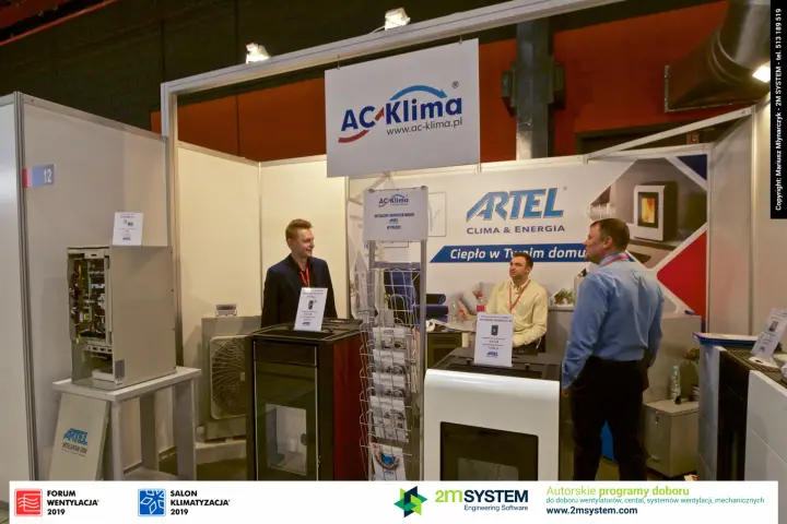 Wider view of AC-Klima stand 12 with stoves, outdoor unit and brochure rack