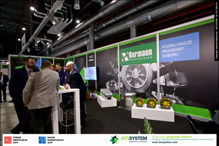 Yellow axial duct fans under the Harmann "Poznaj nasze programy doboru" wall at Forum Wentylacja 2019