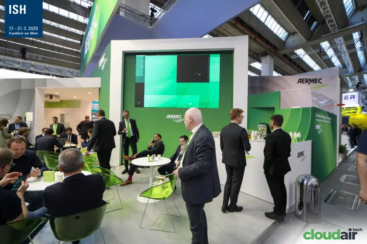 Aermec meeting lounge with green chairs and a large video wall at ISH 2025