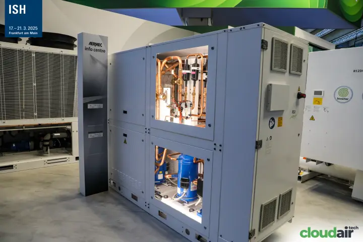 Aermec R32 unit with illuminated windows onto compressors and piping at ISH 2025