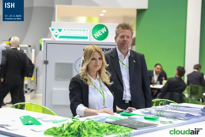 Aermec staff at the reception desk with green lanyards and brochures at ISH 2025