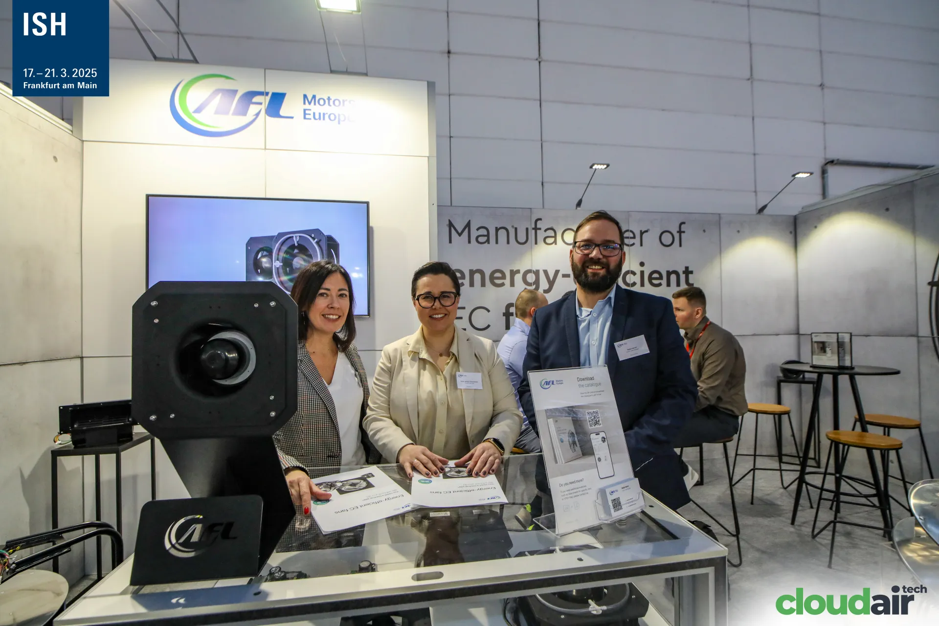 AFL Motors Europe team with catalogues and a mounted EC fan at ISH 2025