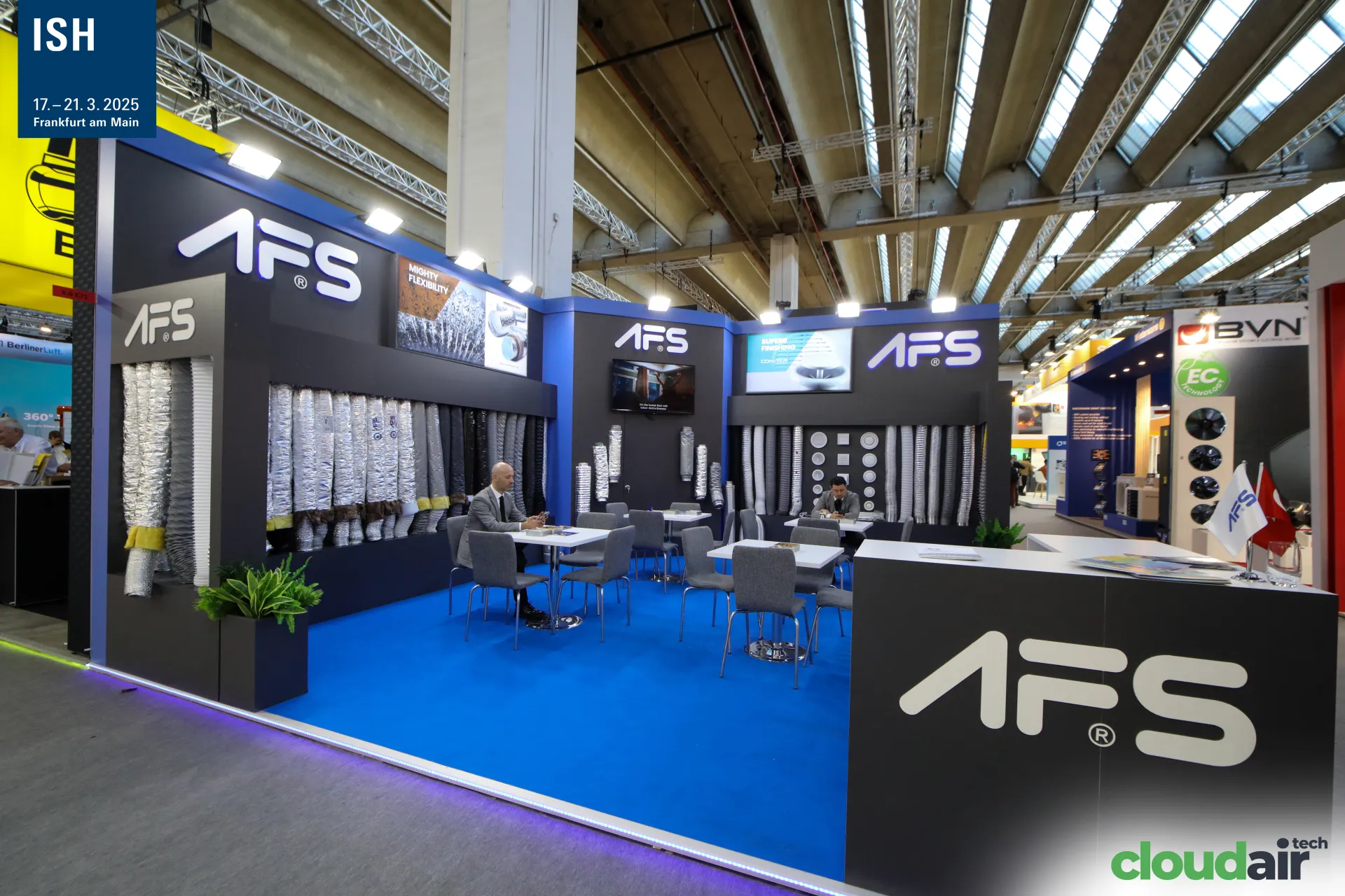 AFS stand with walls of flexible ducts, diffusers and a blue meeting area at ISH 2025