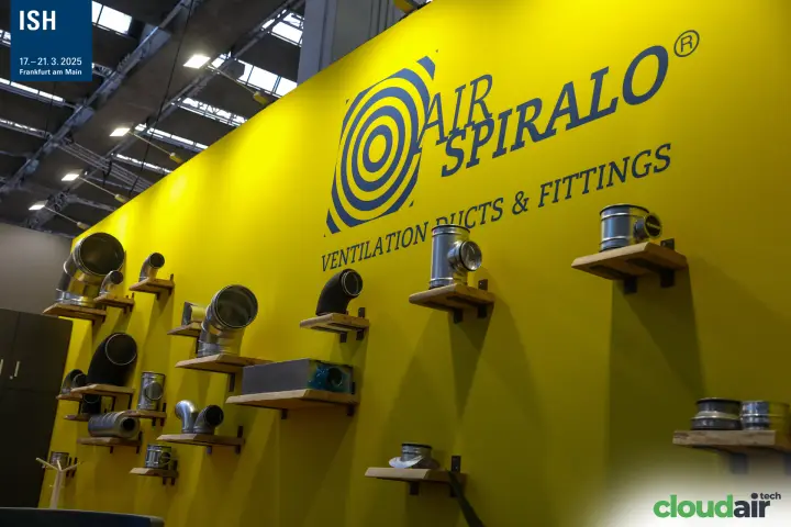 Air Spiralo yellow wall of duct bends and tees on wooden shelves at ISH 2025