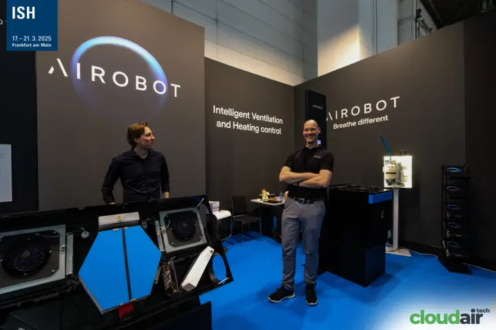 Airobot staff smiling behind the opened ventilation unit at ISH 2025