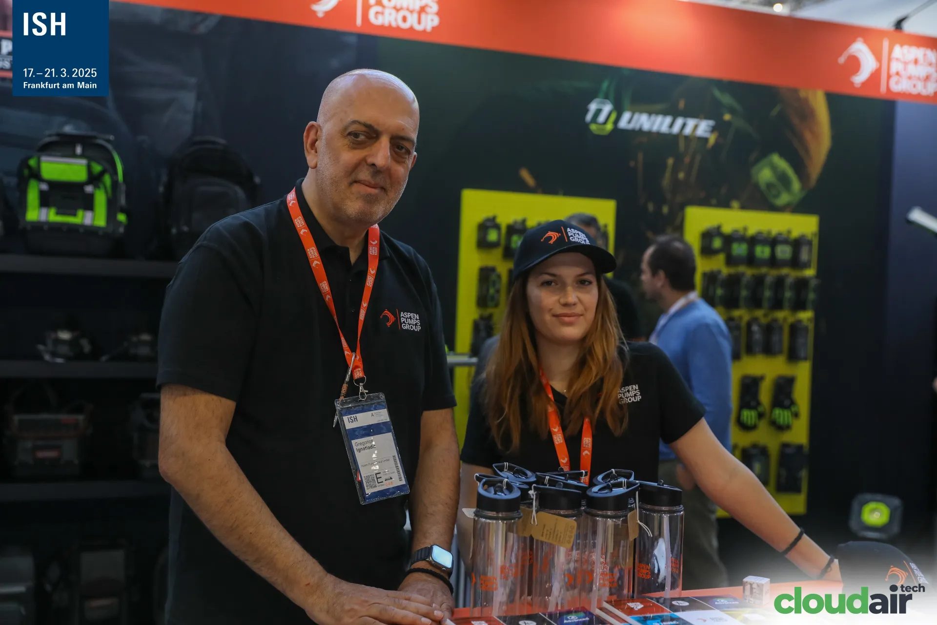 Aspen Pumps Group staff at a counter with branded bottles at ISH 2025