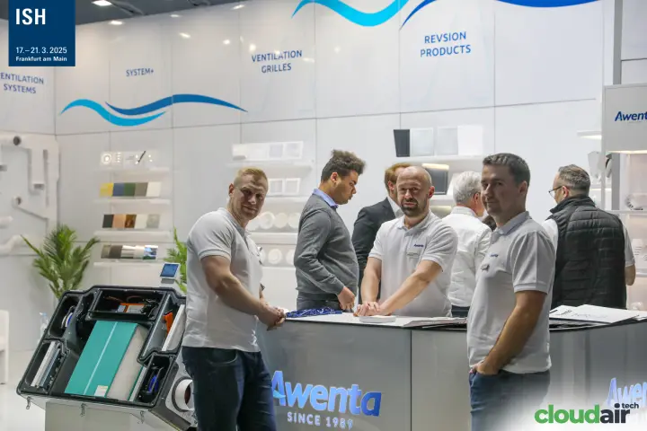 Awenta team at the counter beside an opened heat recovery unit at ISH 2025