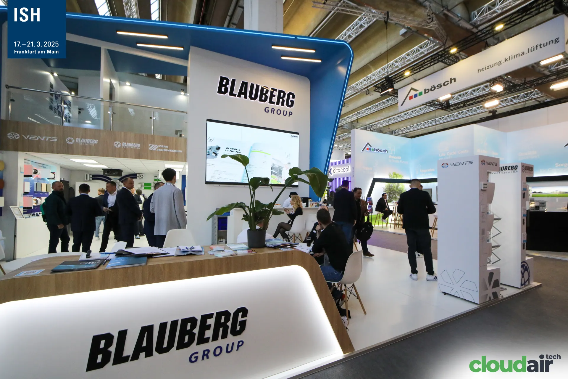 Blauberg Group reception counter with Blaubox screen and mezzanine logos at ISH 2025