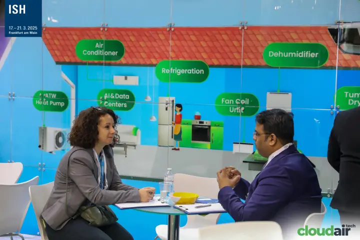 Business meeting at Indus in front of an application wall graphic at ISH 2025