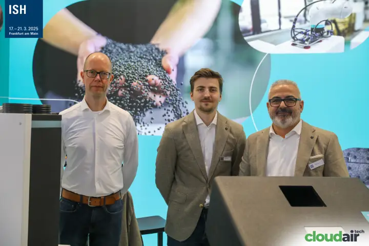 Close portrait of the team in front of a granulate and robotics graphic