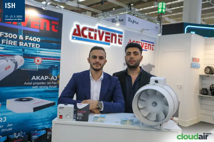 Closer portrait at the Activent counter with jet fan poster behind