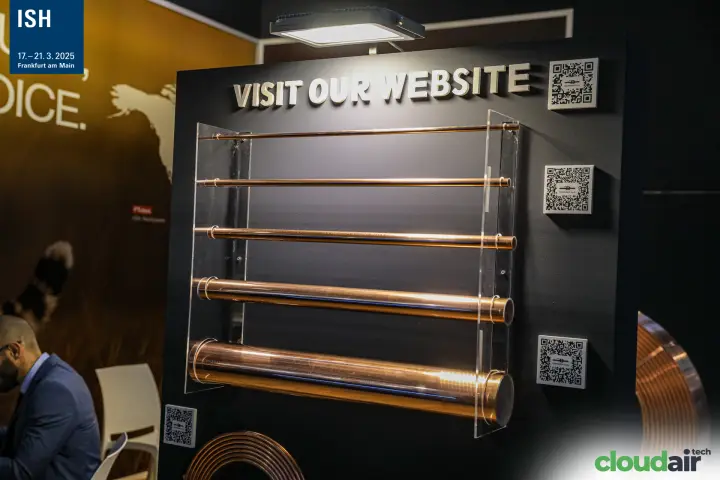 Copper tubes in several diameters on a "Visit our website" board at ISH 2025
