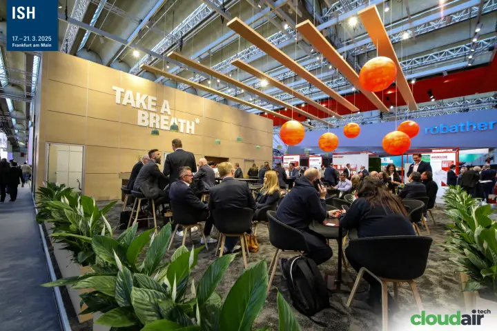 Crowded "Take a Breath*" lounge with orange globe lights at ISH 2025