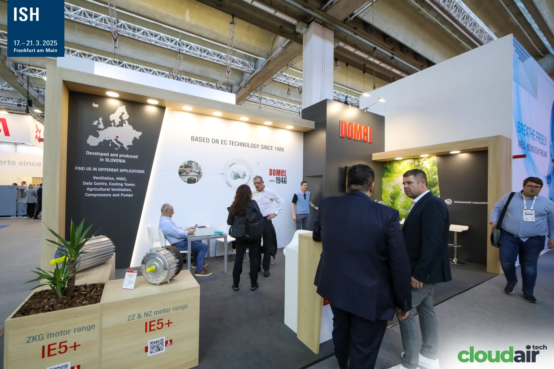 Domel stand with Europe map and IE5+ motors on wooden plinths at ISH 2025