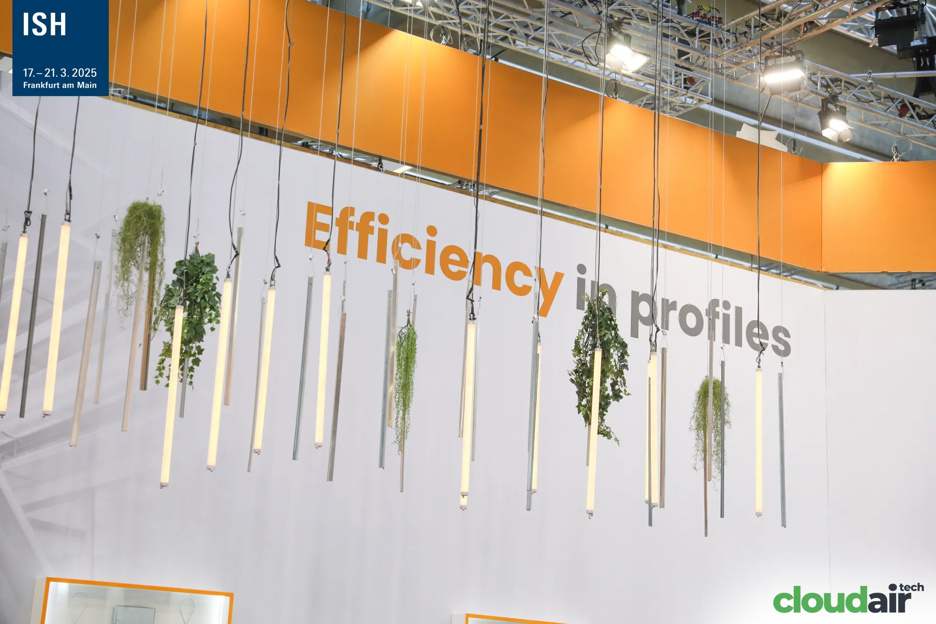 Efficiency in profiles slogan with suspended lit profiles and plants at ISH 2025