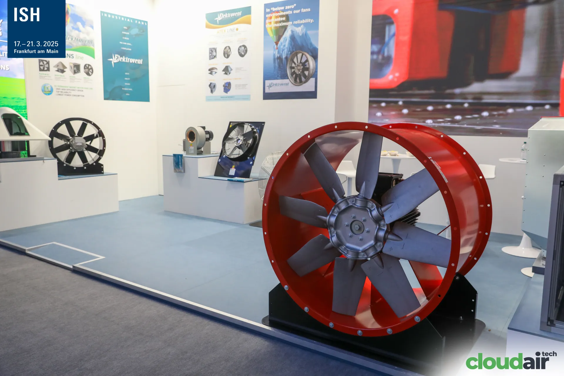 Elektrovent red axial fan in front of an industrial fan display at ISH 2025